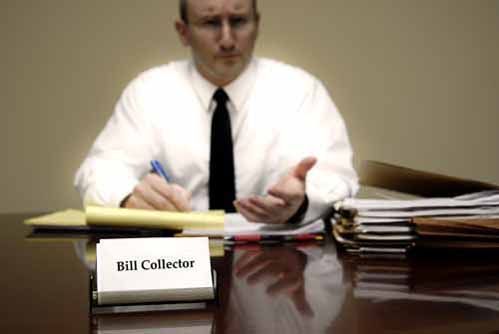 A Nebraska Collection Agent sits at a desk